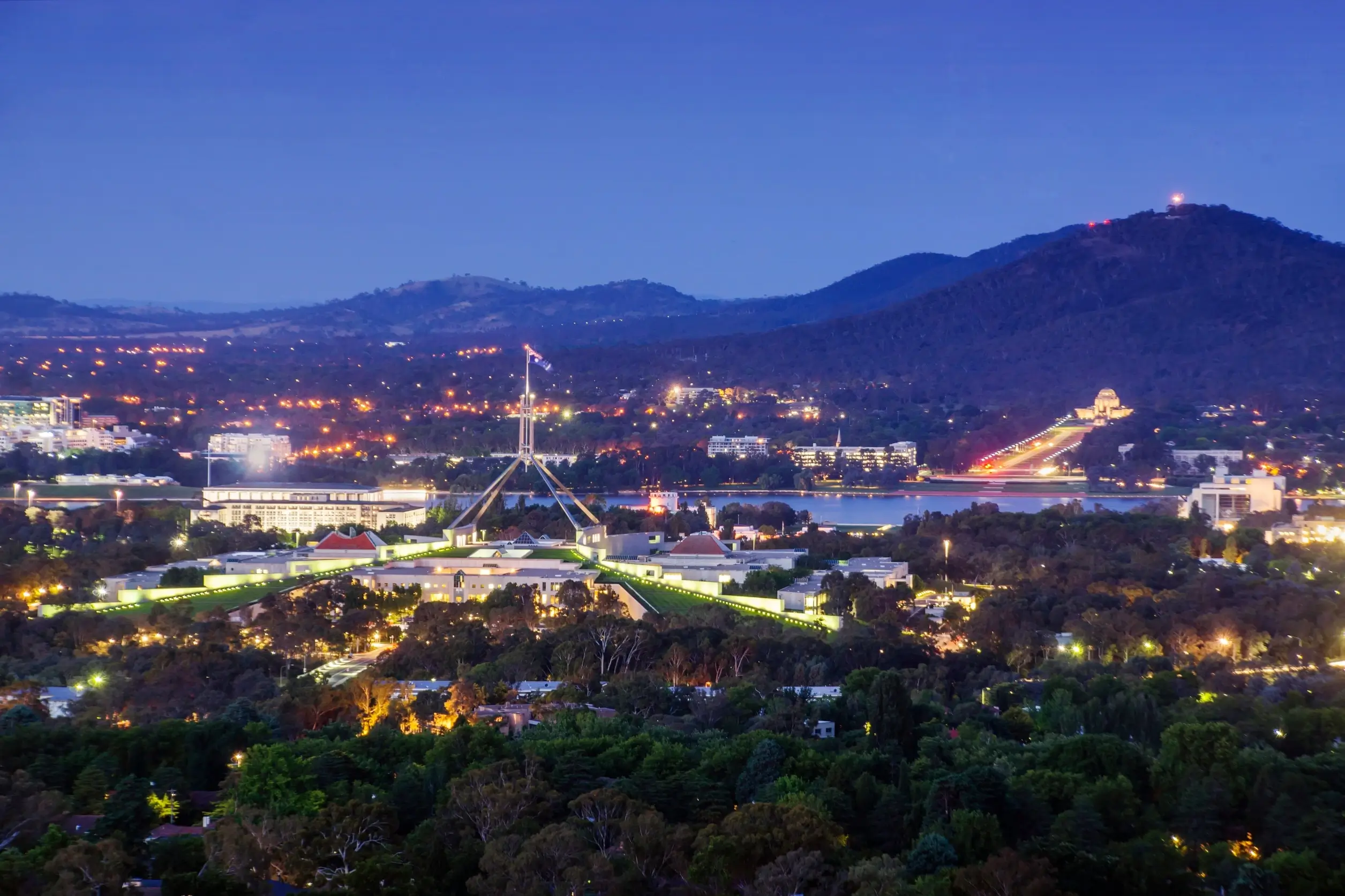 Night view of Parliament House and the Canberra city skyline