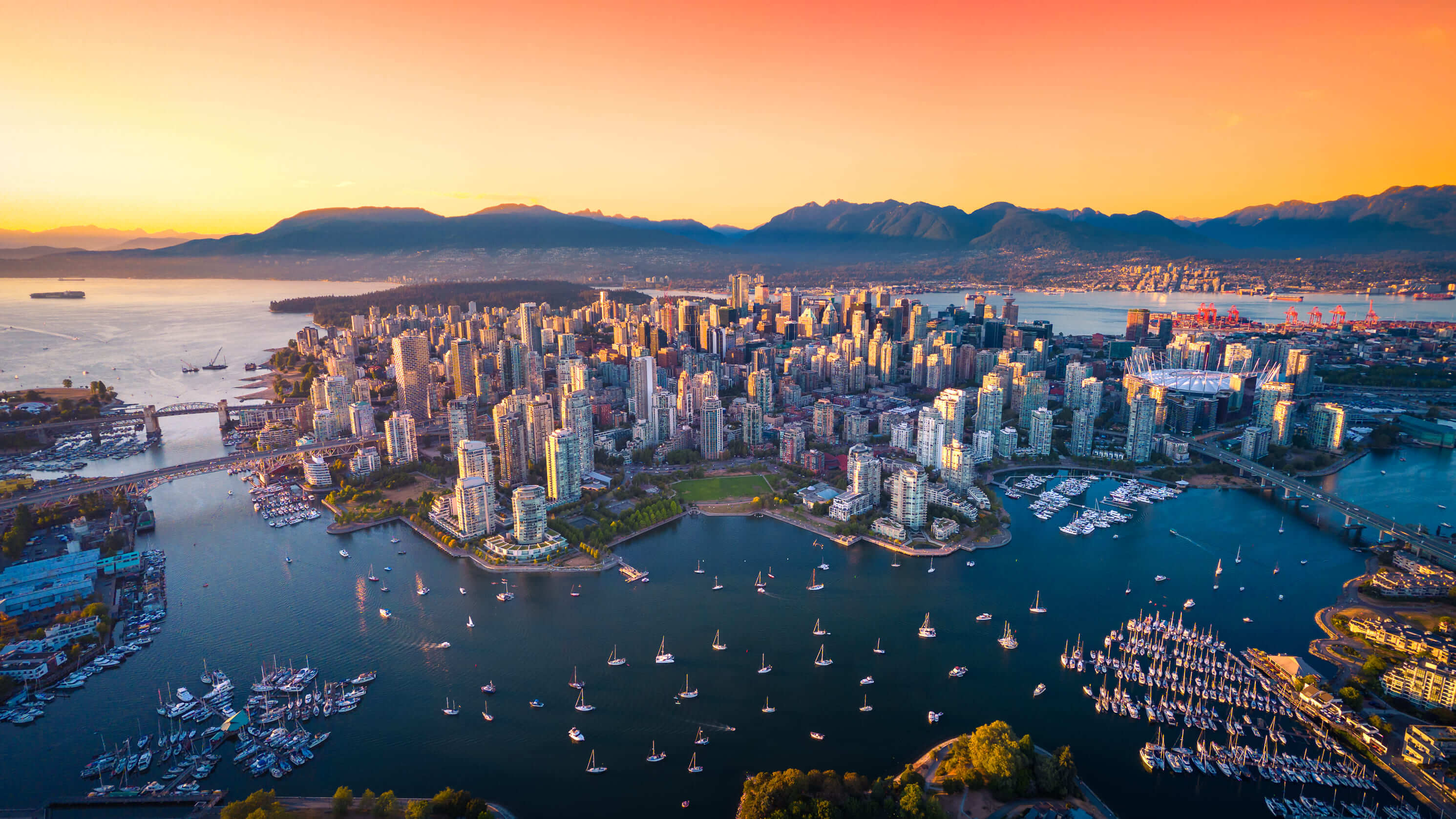 Aerial view of Vancouver downtown peninsula and False Creek at sunset