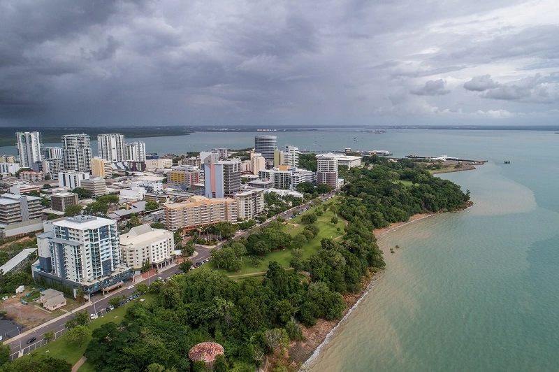 Coastal city skyline with waterfront and greenery