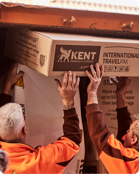 Kent Removals workers loading International TravelPak box into storage container