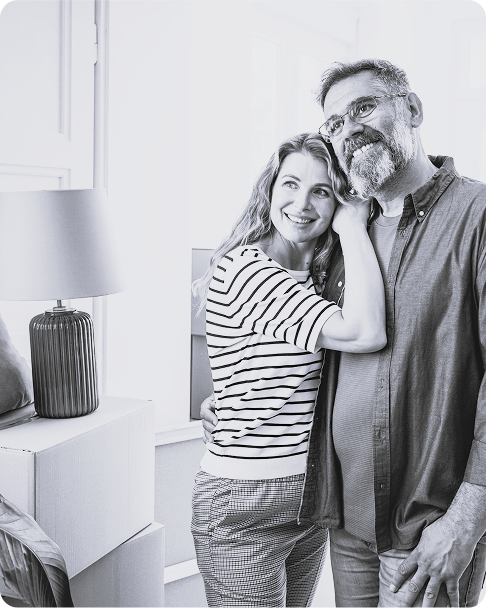 Couple in new home surrounded by moving boxes after relocation with Kent Removals & Storage