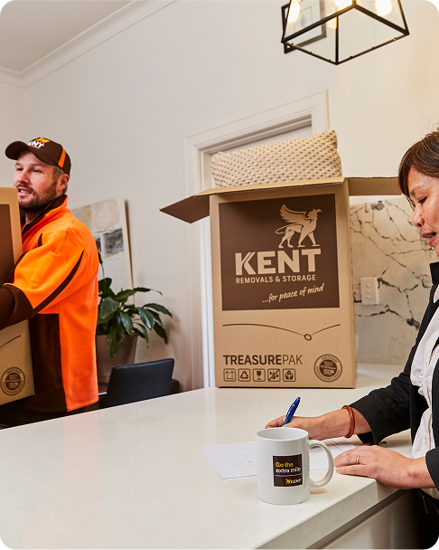 Kent Removals staff delivering and handling packed moving boxes inside home