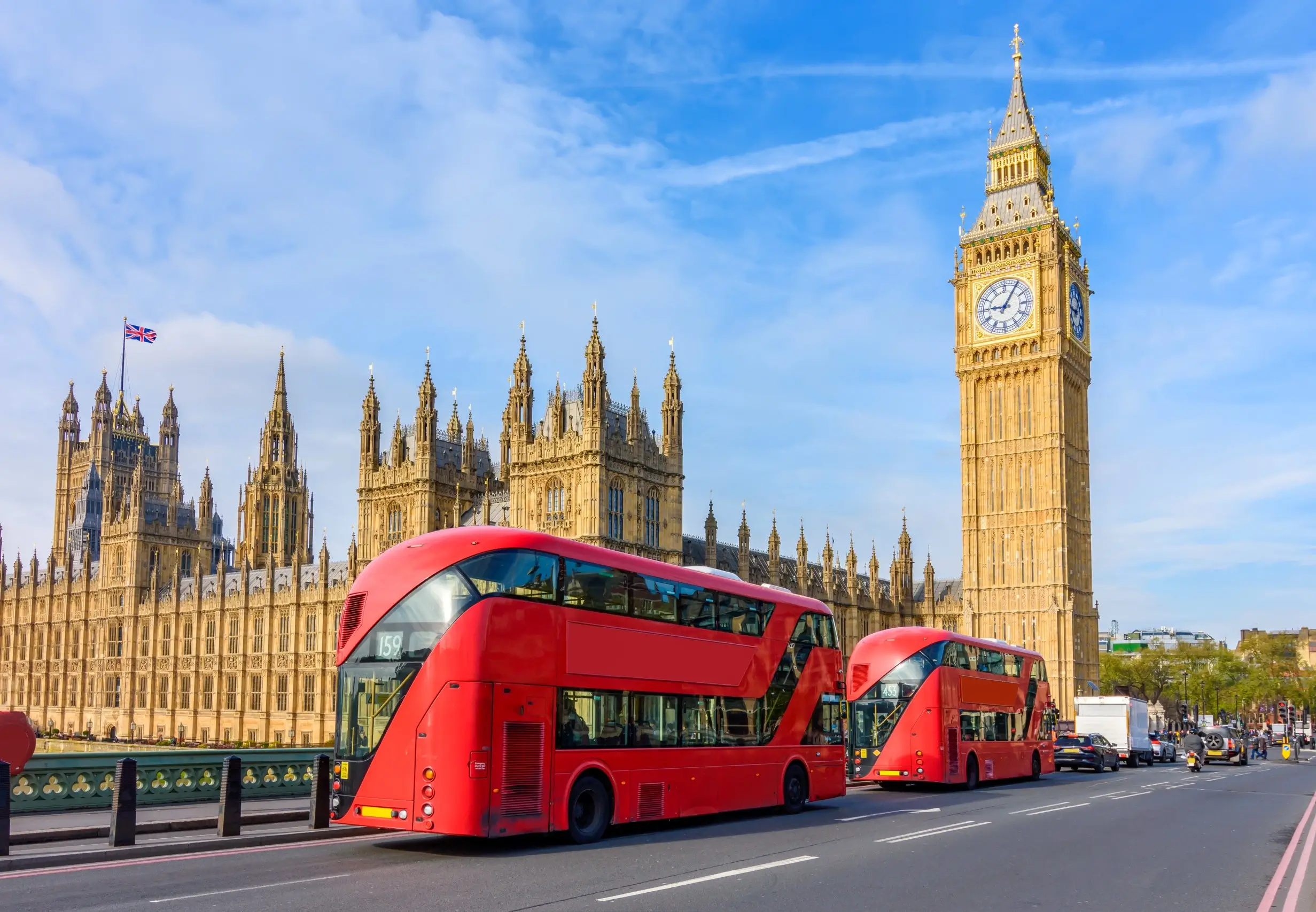 Red double-decker buses in front of Big Ben and Houses of Parliament in London