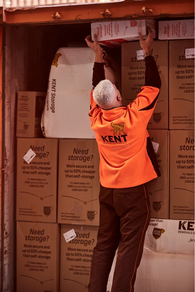 Kent Removals staff loading moving boxes into storage container