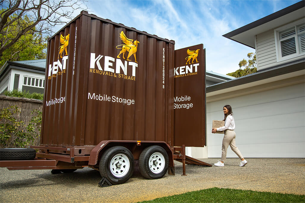 Woman carrying a box to a Kent mobile storage unit