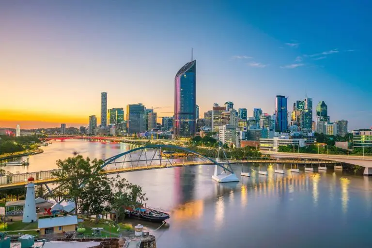 Brisbane city skyline and river at sunset with Goodwill Bridge in foreground