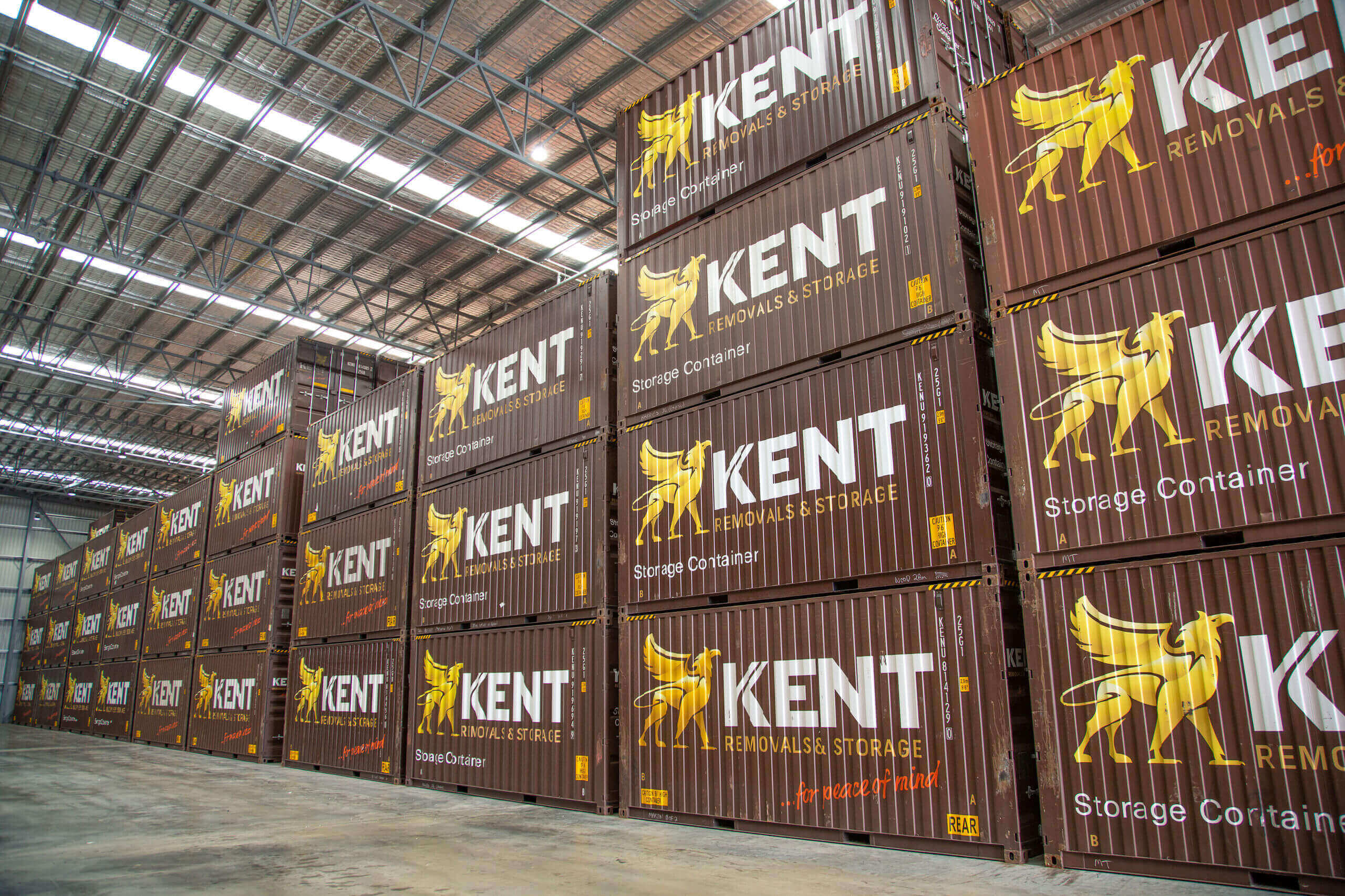 Kent Removals & Storage containers stacked inside a warehouse