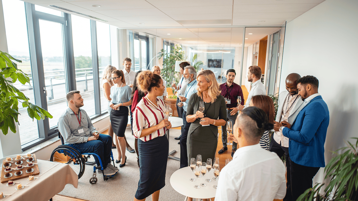 Business professionals networking during office relocation event with Kent business relocation services